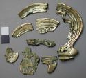 Metal fragments, engraved designs, gold plated, corroded