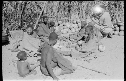 Group at Chukudu sitting beside pile of tsama melons