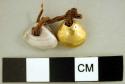 Small knotted piece of string with one gold representation of a bivalve shell, a
