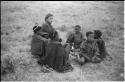 Elizabeth Marshall Thomas and children sitting around the fire