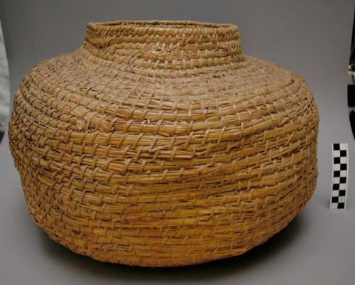 Jar-shaped basket, coiled. Geometric designs.