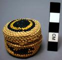 Miniature wrapped twined grass basket (A) with lid (B); whale motif