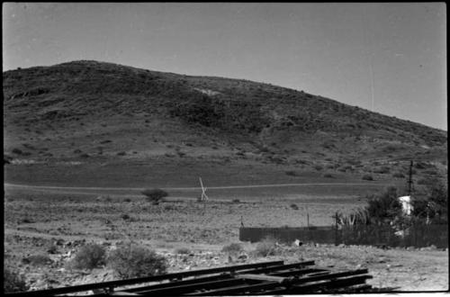 Fenced enclosure, with hill in background