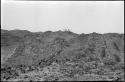 Men standing on the top of a distant hill