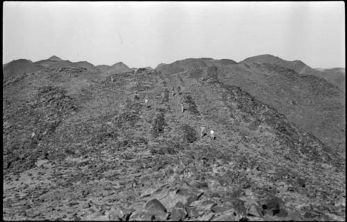 Men descending a hill