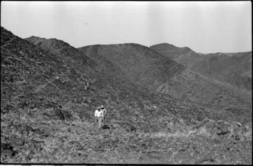 Men descending a hill