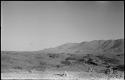 Small piles of rocks, with hills and mountains in background