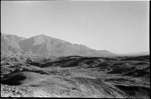 Small piles of rocks, with hills and mountains in background