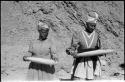 Two women standing and mining by panning