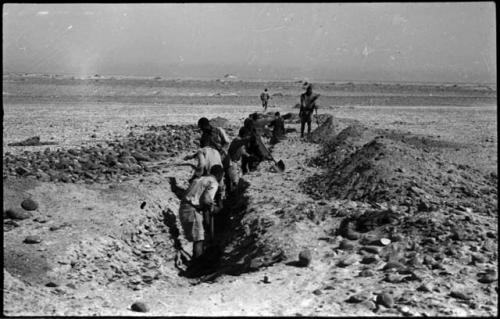 Men digging a ditch