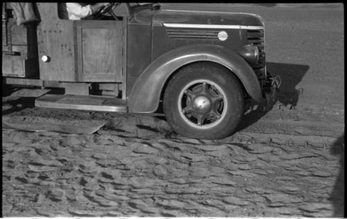 Front of expedition truck, with sand and chains