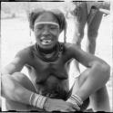 Woman sitting and showing her filed teeth