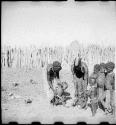 Women and children standing inside their kraal