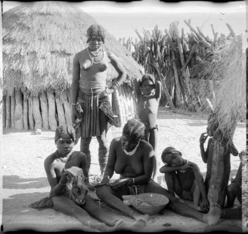 Group of women working on part of a garment or ornament