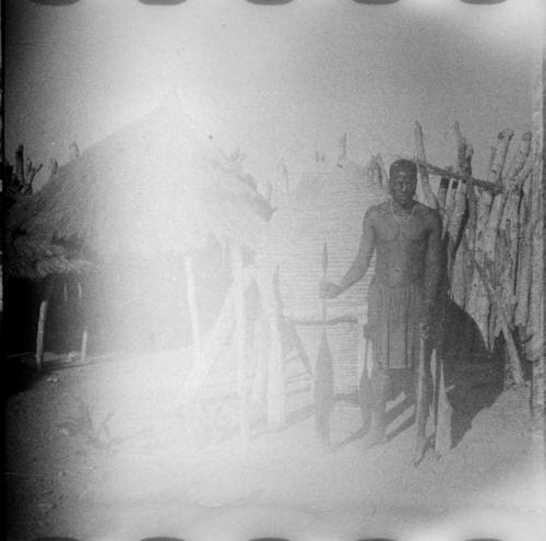 Man standing in front of a storage basket (overexposed)