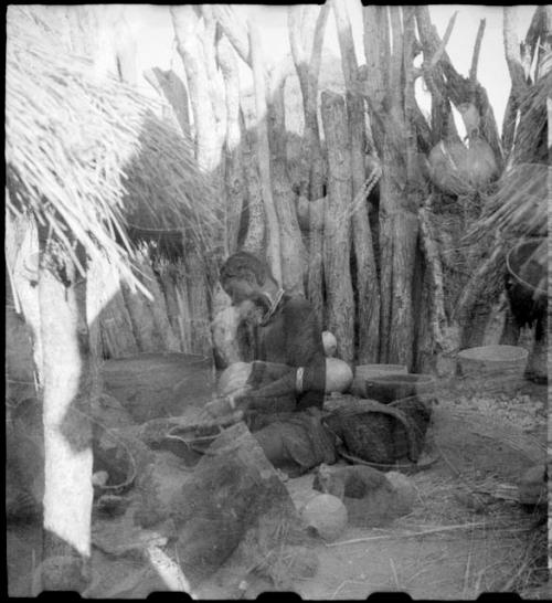 Woman sitting and making a pot (double exposure)