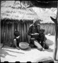 Elderly woman feeding two children