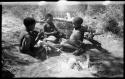 Tsamgao, "Little ≠Gao," and /Gaishay (!U and ≠Toma's son), seated and wearing shoes