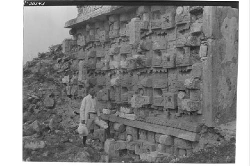 Man standing next to sculptured lower zone of Structure 2C6