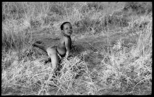 "Little ≠Gao" lying on the ground, his legs spread apart