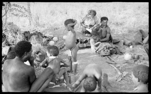 !Ungka Norna, Bau, /Gaishay (Di!ai's son), /Naoka, her son, /Gaishay, Elizabeth Marshall Thomas taking notes, and other unidentified people