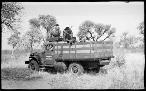 Power wagon with Elizabeth Marshall Thomas on top and unidentified Ju/'hoansi and expedition members in the back