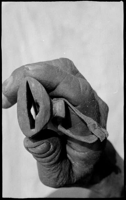 Person's hand holding the end of a knife shaft, showing the opening