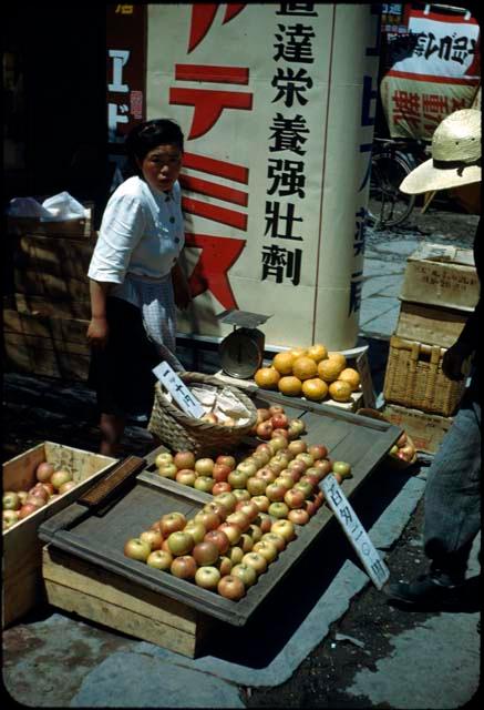 Woman and fruit stand