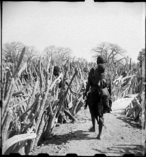 Two women walking inside their kraal