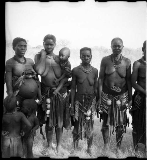 Circle of women standing, clapping and singing