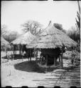 Two storage baskets with thatched roofs