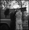 Kernel Ledimo and Nicholas England tying ropes to truck