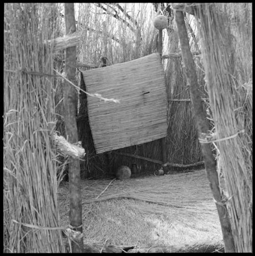 Fence hut, showing inside doorway and grass on floor