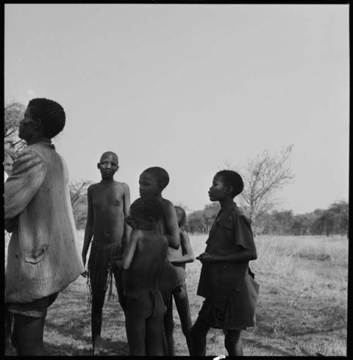 Group of people standing on the shore watching the expedition cross the Muzwamo River