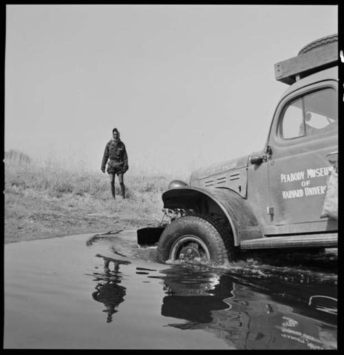 Kernel Ledimo guiding the expedition truck (Dodge) as it crosses the Muzwamo River