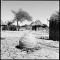 Basket, with huts in background