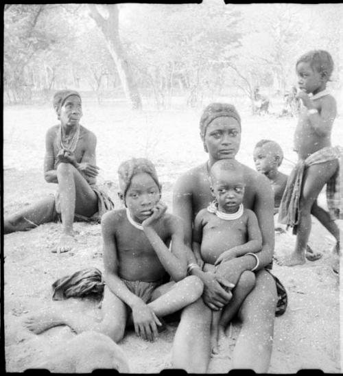 Women sitting, with children sitting and standing