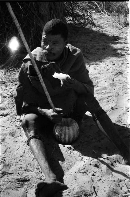 Man with tsama melon, holding digging stick