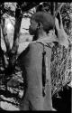 Child with long narrow bag hanging from kaross