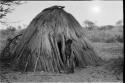 Child standing by the doorway of hut