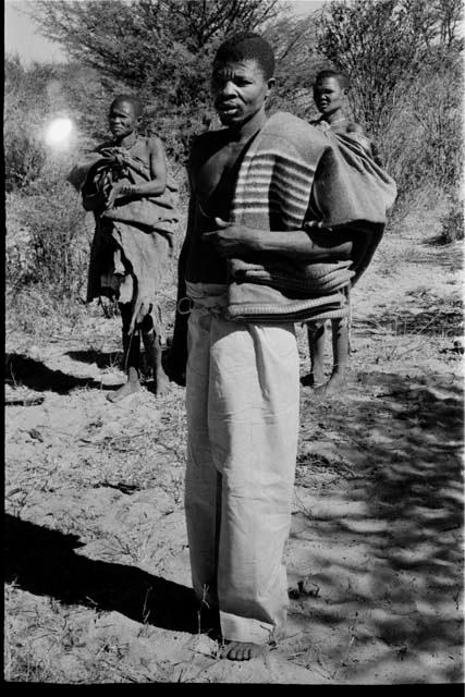 Man (who is Kgalagari) and two women standing behind him