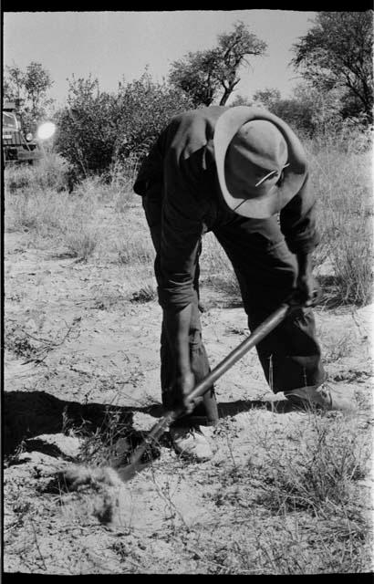 Expedition member digging with a shovel