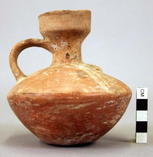 Pottery jar, handle on side, red, with incised ornament
