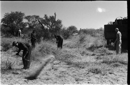 Expedition members clearing the ground using shovels