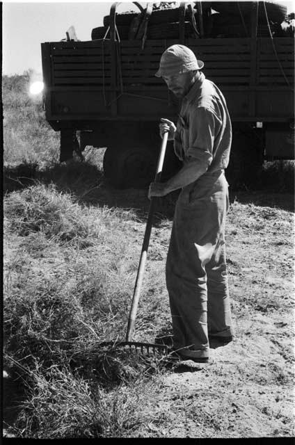 Robert Story raking up grass