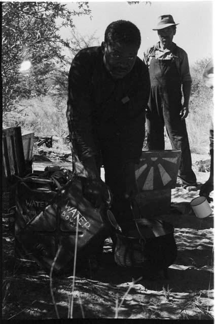 Philip Hameva filling a pot with water