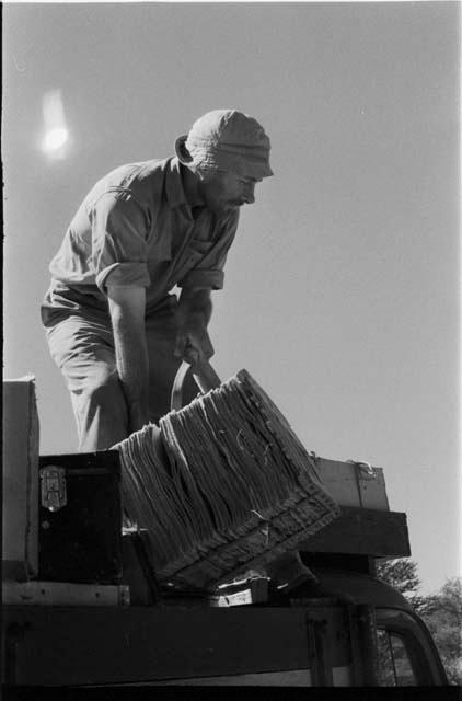 Robert Story on truck, offloading material