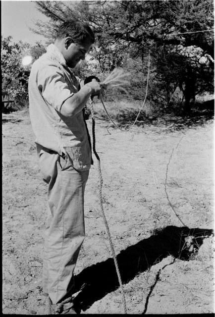 Bill Donnellan standing holding end of rope