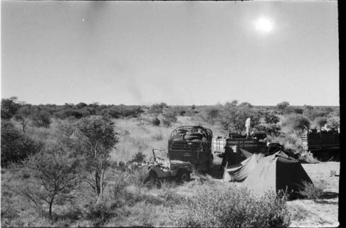 Tent and expedition trucks, distant view