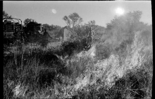 Two expedition members setting a backfire to protect the camp from approaching brush fire